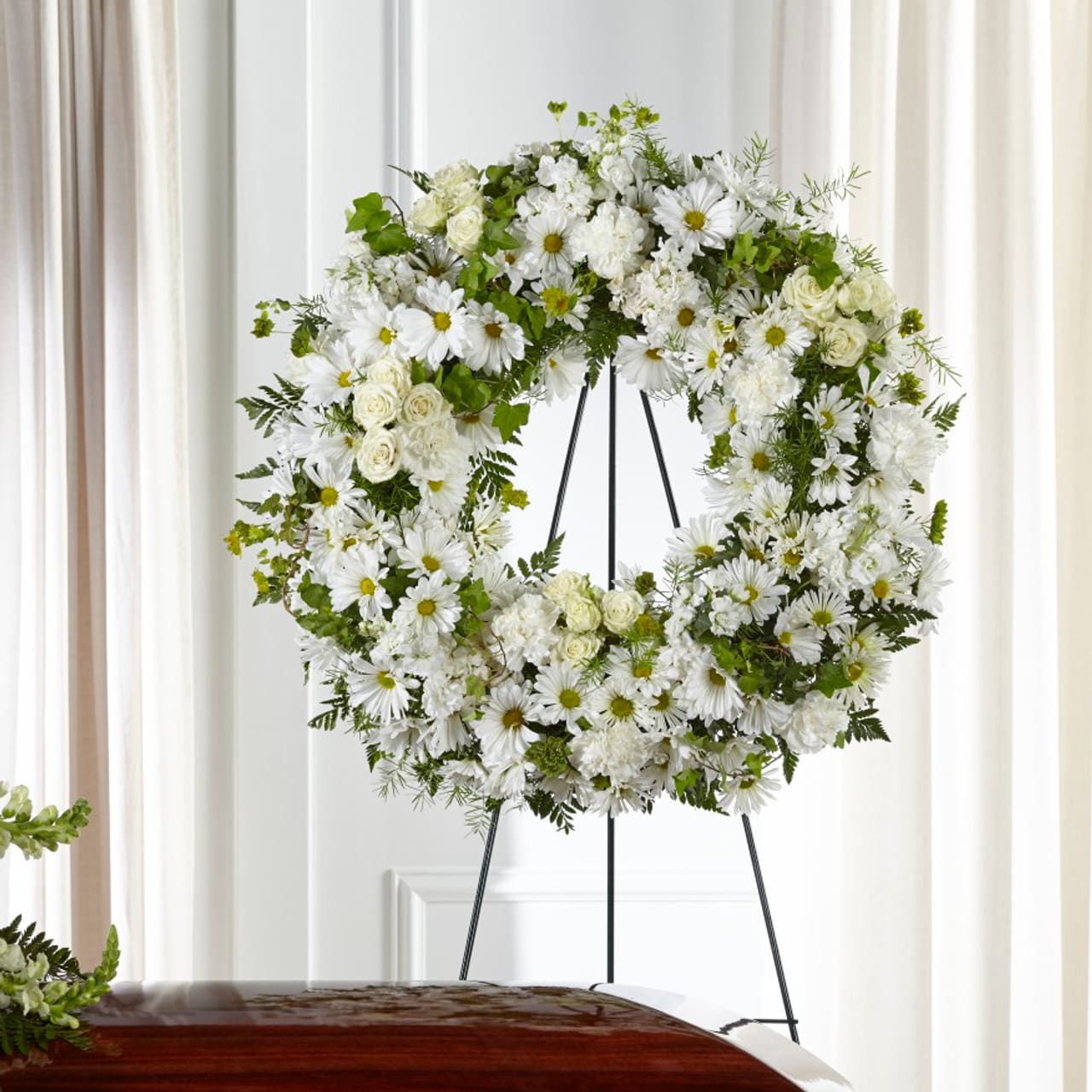 Faithful Wishes Wreath - Your thoughtful messages are captured through a simple and elegant display of white flowers. Our Faithful Wishes™ Wreath combines classic white blooms in a timeless wreath to showcase your love, peace and respect. Wreath is approximately 26&quot; dia.
