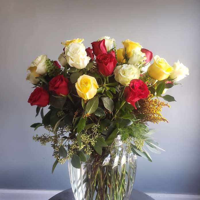Thirty-six Mix (Roses) - A trio-color combination of beautiful long stemmed roses in a glass vase.