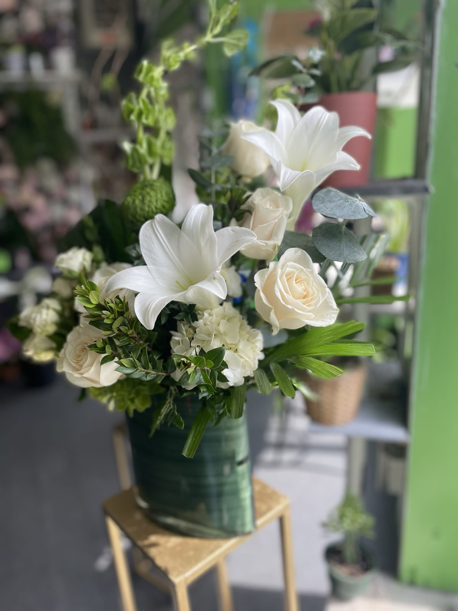 Winter Fresh  - This beautiful arrangement has gorgeous white fresh flowers and white lilies, white roses, white hydrangeas, green hydrangeas, bells of Ireland, green mums, and fresh greens.