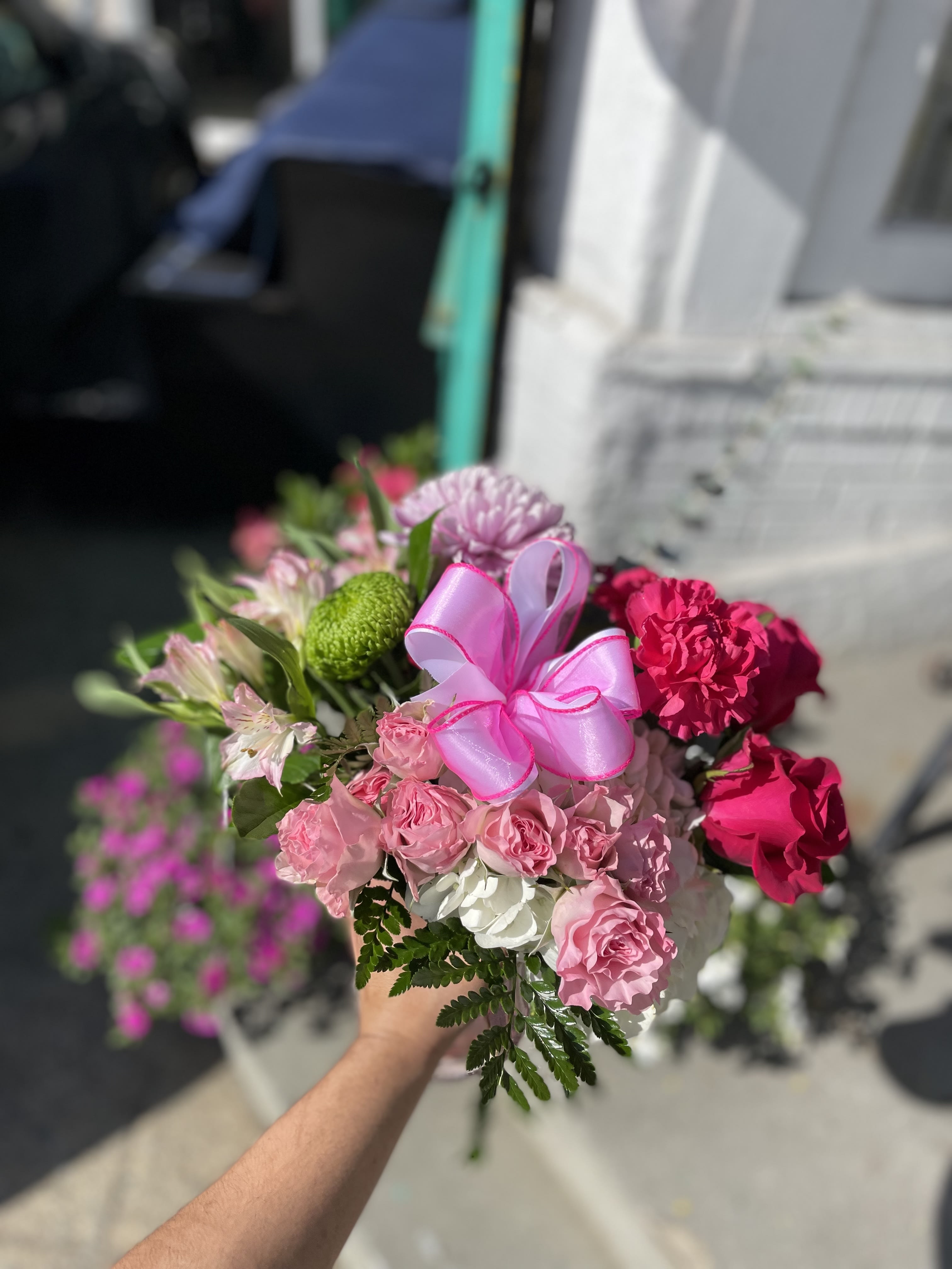 Pinky Love - This gorgeous pink arrangement has pink carnations, pink roses, white hydrangea, pink spray roses, and fresh greens.