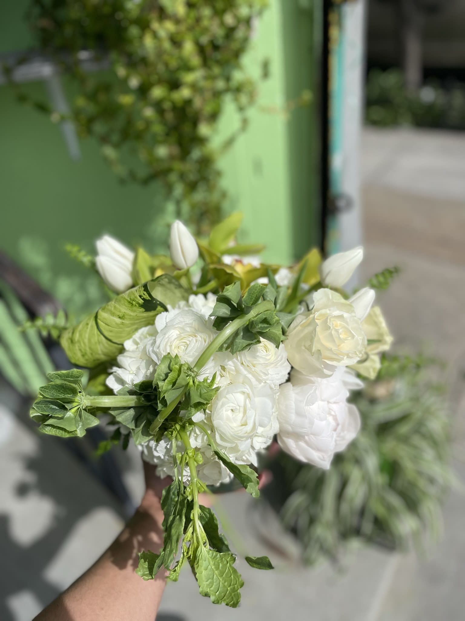 Don’t Let Go - This beautiful arrangement has nice colors of flowers it has green orchid, white tulips, white hydrangea, bells of irland, and fresh greens.