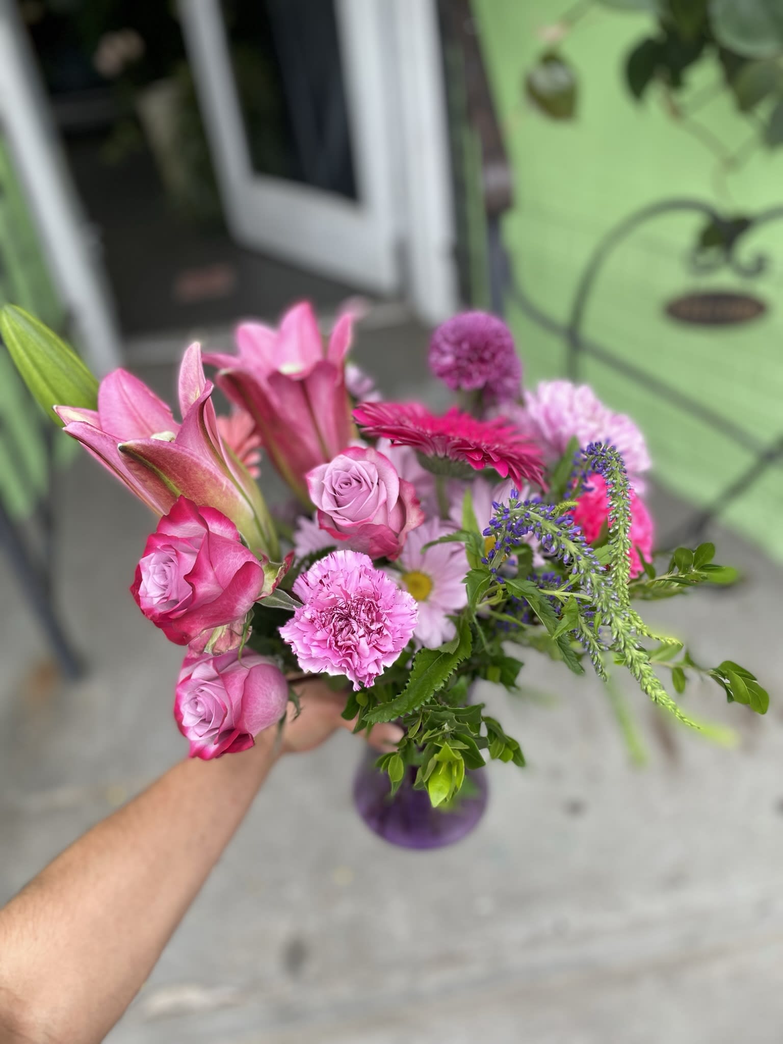 Amour  - This perfect arrangement has lavender roses, pink lily’s, pink gerbera, lavender carnations, lavender deasis, purple camilia,lavender and purple mums.