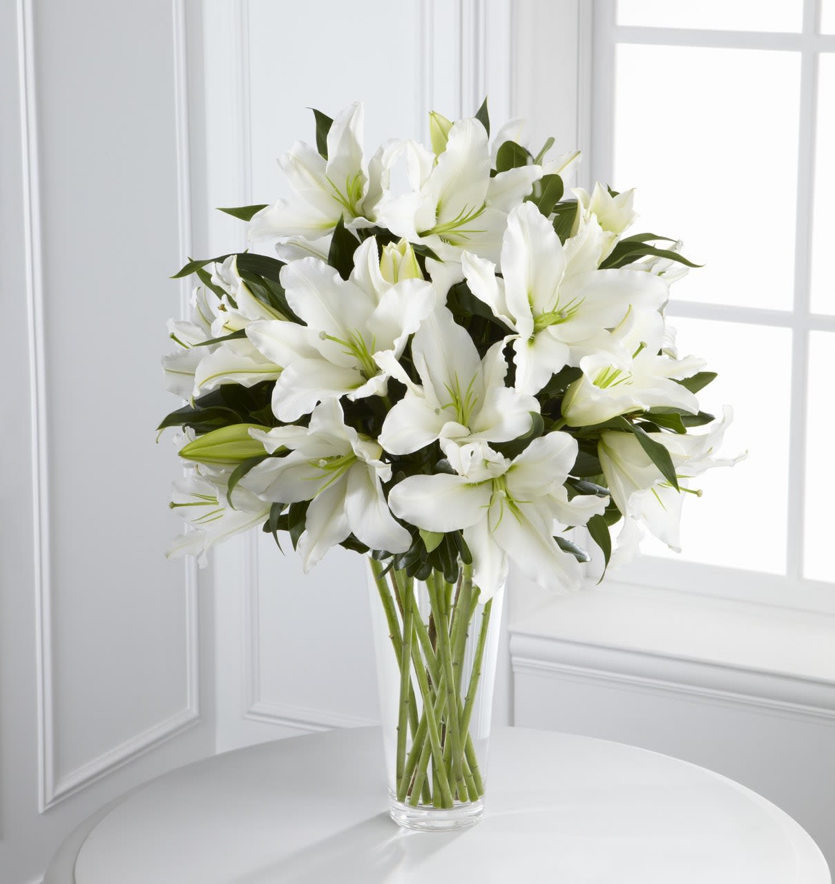SAFF The Light in Your Honor Bouquet - The Light in Your Honor Bouquet is a beautifully bright arrangement bursting with elegant fragrance to convey your deepest sympathies for the loss of their loved one. A stunning bouquet of gorgeous Oriental lilies are accented with lush greens and seated in a clear glass vase to create a bouquet that is serenely sophisticated, offering comfort and peace in their time of need. GOOD bouquet includes 8 stems. Approximately 22&quot;H x 15&quot;W.  Your purchase includes a complimentary personalized gift message.