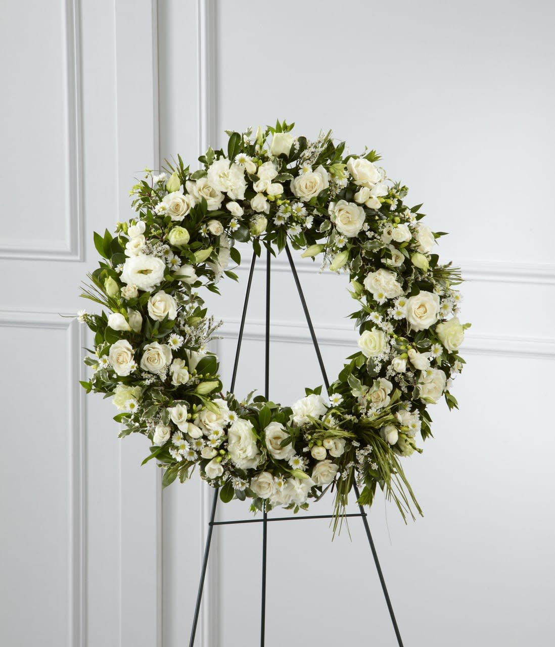SAFF The Splendor Wreath - The Splendor Wreath is a symbol of lasting love and kinship, whether for the deceased or in comfort of those suffering from a loss. Elegant white freesia, double lisianthus, spray roses, Monte Casino asters and limonium are accented with a variety of lush greens and green raffia ribbon, perfectly arranged in the form of a wreath, to create a beautiful way to display your sincere sentiments. Approximately 22-inches in diameter.  Your purchase includes a complimentary personalized gift message.