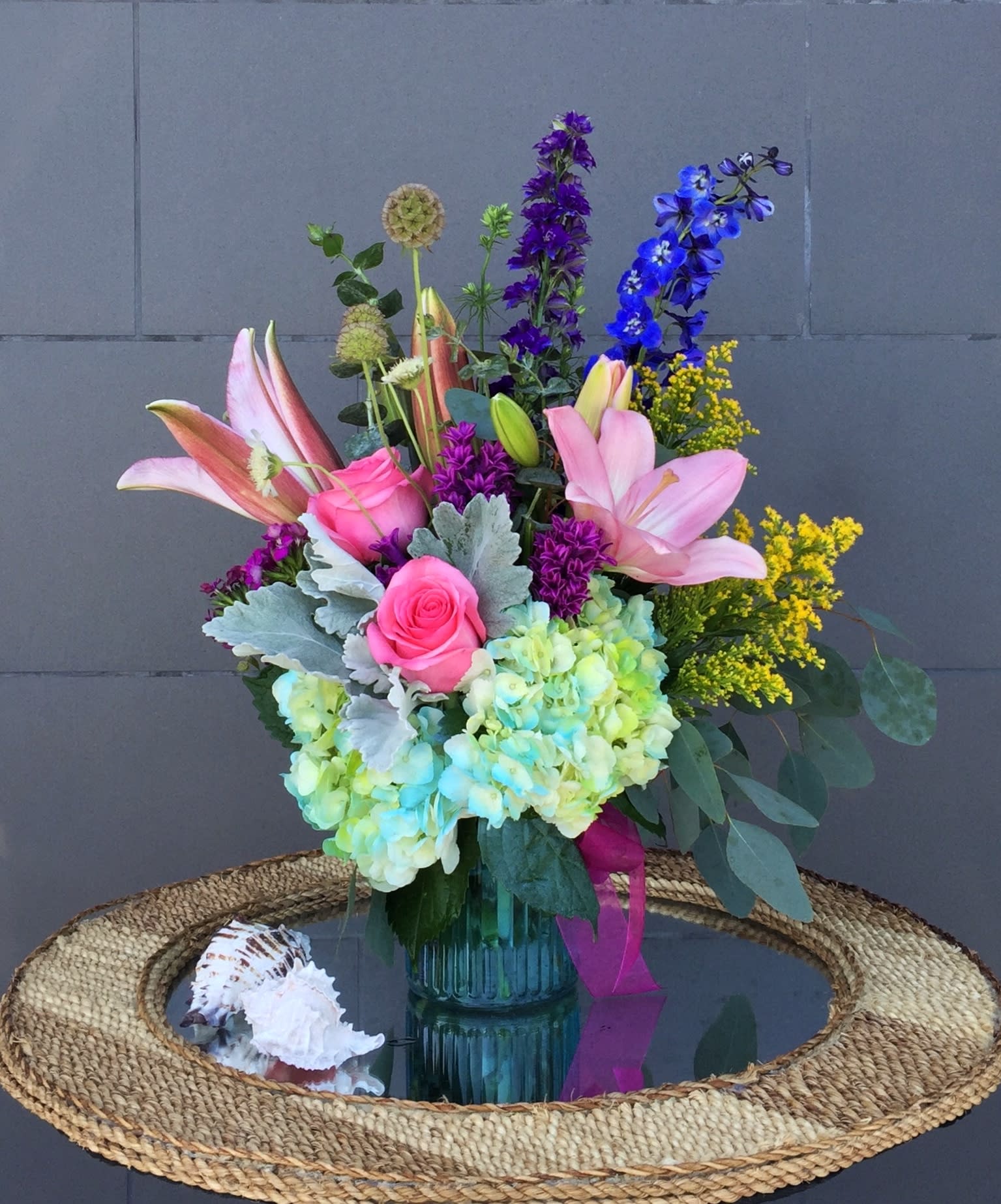 Go Beach - Spring mixed flowers including lily, rose, delphinium, hydrangea... and accents in a nice vase. 