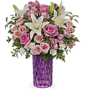  Rose Glam - Bursting with perfect pink roses and snow white lilies, this sparkling cut glass vase in the most glamorous shade of amethyst is a Mother's Day gem.