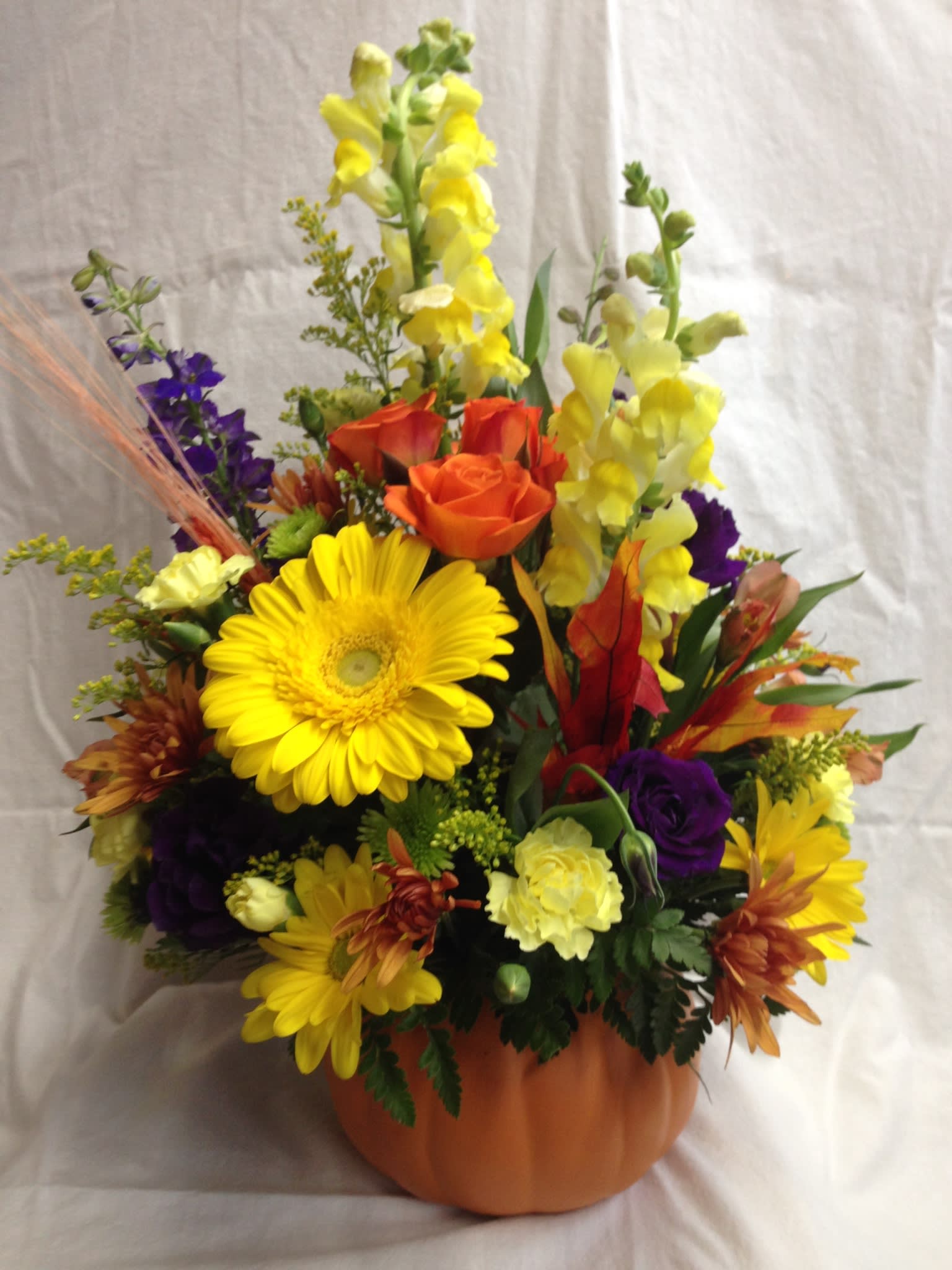 Pumpkin spice  - A keepsake pumpkin with snapdragons, gerbra daisies, fall mums and leaves.
