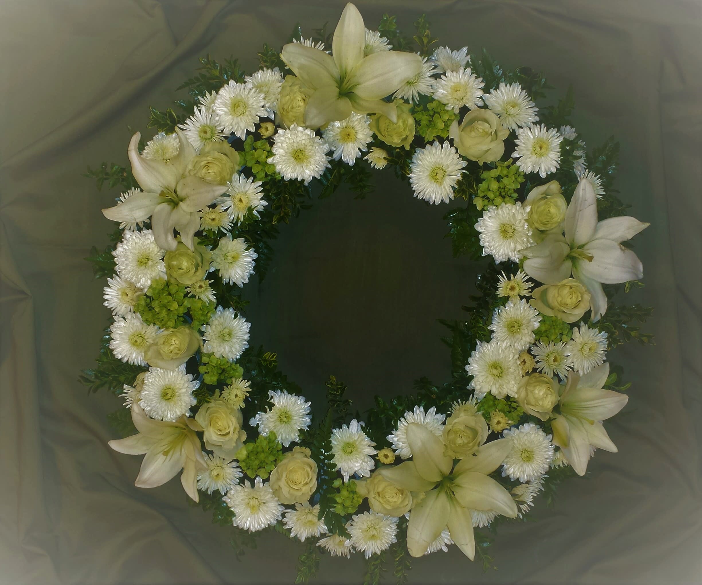 Purity and Light Wreath - A lovely Classic Elegant tribute of purity and light. This wreath contains roses, lilies, chrysanthemums and hydrangeas.   