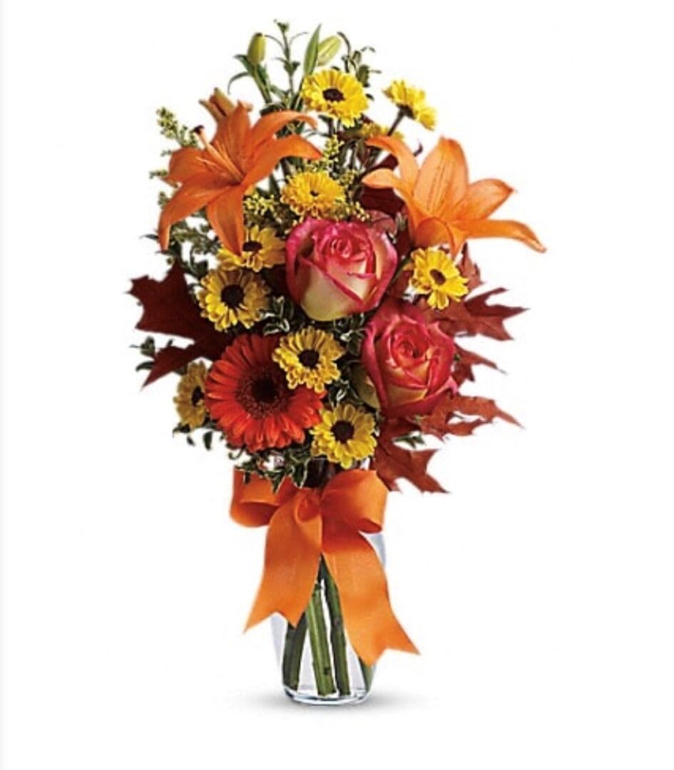 AUTUMN BREEZE - &quot;A burst of beauteous blooms in autumn shades of orange and yellow is mixed with a handful of oak leaves, then delivered in a clear glass vase adorned with a bright satin ribbon. A splendid gift for birthdays or any fall occasion.  A mix of fresh flowers such as Asiatic lilies, Viking spray chrysanthemums, roses and a miniature gerbera – in shades of orange and yellow – is arranged with preserved oak leaves in a clear glass vase adorned with an orange satin ribbon.  SET: All-Around All prices in USD ($)&quot;