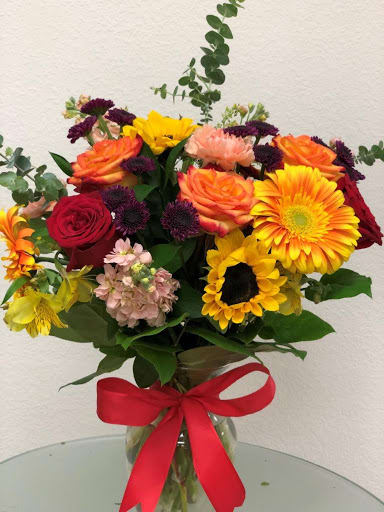 AMAZING YOU - &quot;The bright stuff for punching up anyone’s mood! Bring happiness to any day with this bold, sunset-inspired blend of hot red, orange roses and, orange, yellow gerberas daisy in a classic glass vase!  Hot red, orange roses, orange spray roses, orange-yellow gerberas Daisy, hot pink carnations, red miniature carnations, orange snapdragons, yellow alstroemerias, and pink heather are accented with sword fern, huckleberry, seeded eucalyptus, and lemon leaf. Delivered in a clear glass vase.  Orientation: All-Around All prices in USD ($)&quot;