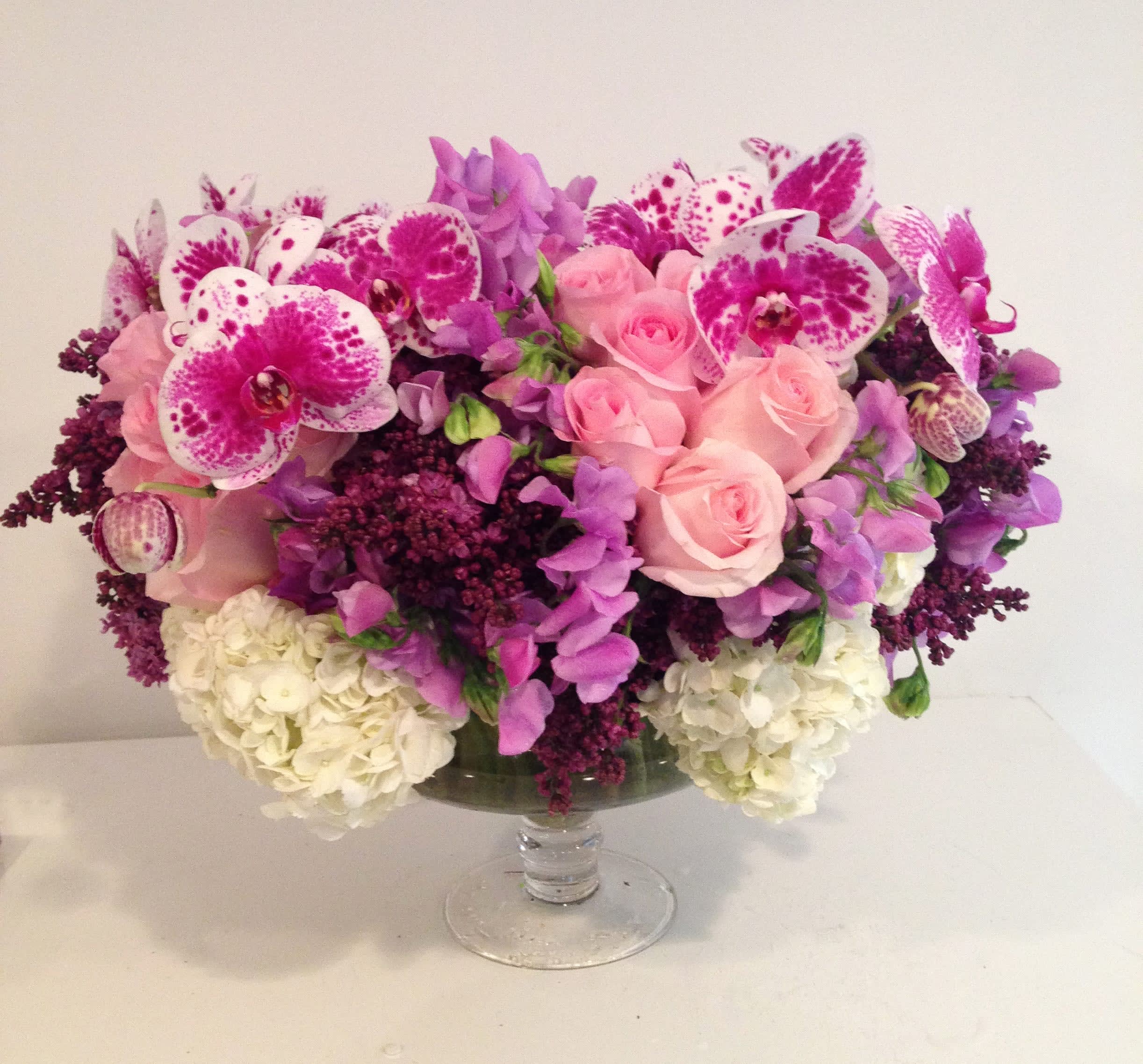 Spectacular Blooms - This beauty includes beautiful roses, orchids, hydrangea and more in elegant pedestal vase 
