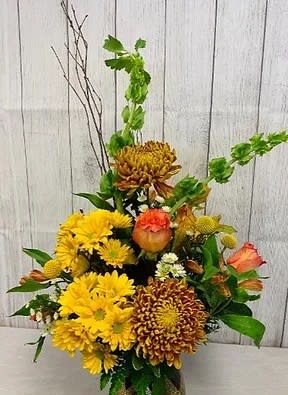 CFF112 - Mixed arrangement in a vase of  fall tone flowers such as daisies, bells of ireland, roses, mums and other flowers,