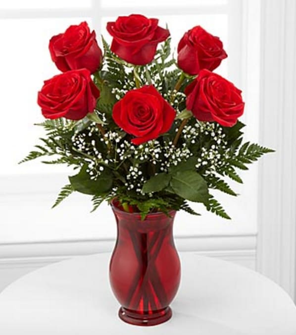 Classic Romance Rose Bouquet   - Six stems of rich red roses are simply accented with Baby's Breath or other accent flower and lush greens to create a bouquet of classic beauty and style.  Bouquet includes 6 stems of roses.  vase color may vary  