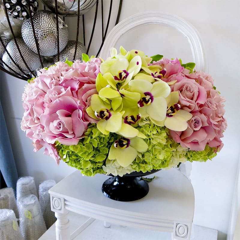 Poppin' Fresh Poppin' Fresh - Perfectly pink roses and lime-green Phalaenopsis orchids in a fresh and fabulous springtime arrangement. The decorative pedestal vase just adds to the bright splendor of this fresh embodiment of spring.