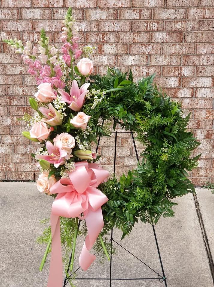 Peach Comfort Wreath - This striking peach wreath is sure to bring comfort to family and friends.  The wreath is decorated with a cluster of peach lilies, roses and stock on a mixed foliage base. The wreath is delivered on an easel.  Standard- 12&quot; wreath Deluxe-     18&quot; wreath Premium-  22&quot; wreath  As Shown : TF196-2