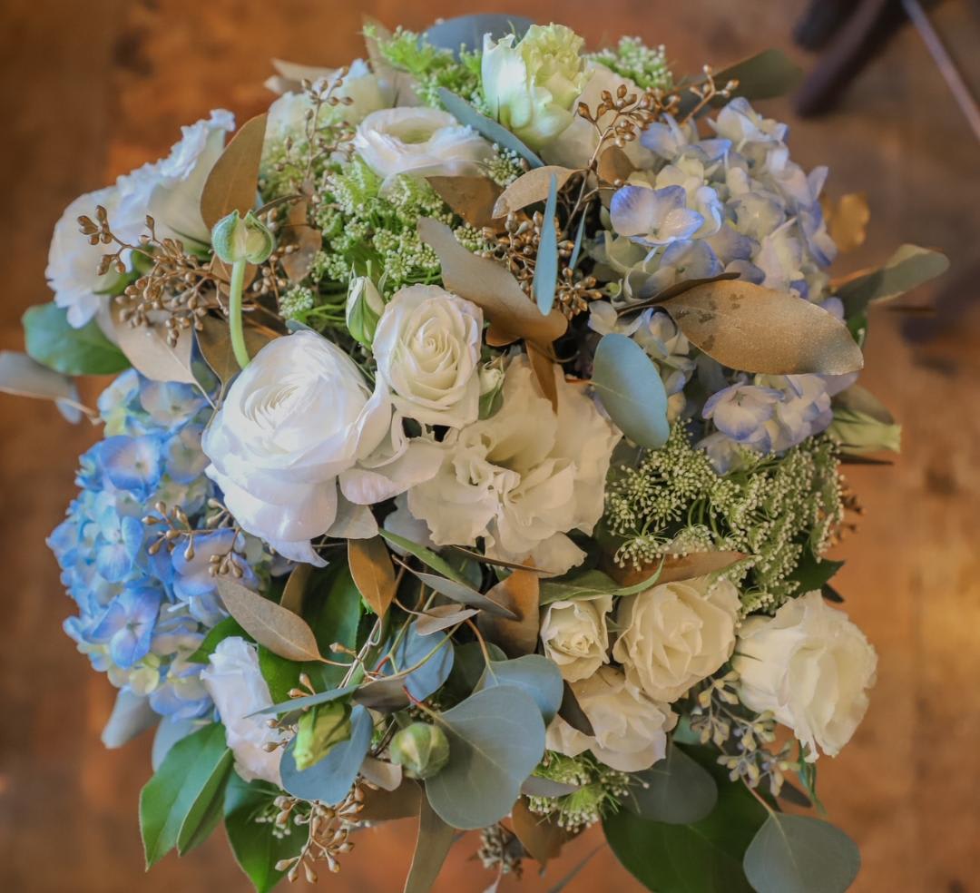Baby Blues - Grace your dinner table with this stunning centerpiece. Touches of gold add richness to the soft blues and fluffy whites. Suitable for an accent arrangement too!
