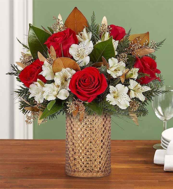 Shining Bright Bouquet Shining Bright Bouquet - All-around arrangement with red roses and white Peruvian lilies (alstroemeria); accented with magnolia tips, seeded eucalyptus and assorted Christmas greenery Artistically designed in our hobnail vase, styled in a champagne mercury finish, adding vintage flair to any décor; measures 6"H x 4"W Large arrangement measures approximately 14"H x 12"W Small arrangement measures approximately 12"H x 10"W Our florists hand-design each arrangement, so colors and varieties may vary due to local availability To ensure lasting beauty, Peruvian lilies may arrive in bud form and will fully bloom over the next few days