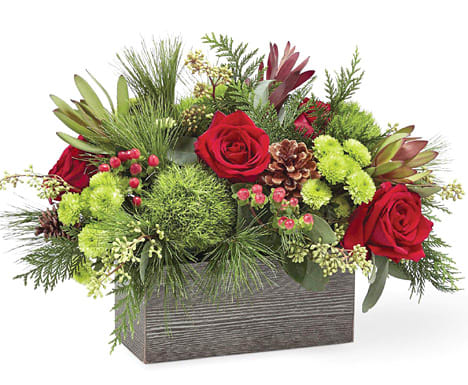 Christmas Cabin  - Inspired by the rustic outdoors of the holiday season, our Christmas Cabin Bouquet brings natural beauty indoors. Filled with red roses, red carnations, green trick dianthus and assorted Christmas greens in a weathered wooden box, your loved ones will be delighted with this gift. Perfect as a centerpiece or decor in their home, this bouquet helps brighten up any occasion this Christmas.