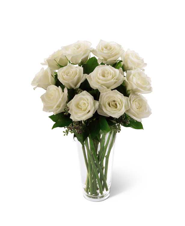 The FTD White Rose Bouquet - The FTD White Rose Bouquet offers a rare beauty of simple elegance that will bring peace and comfort to your special recipient during their time of grief and loss. A bouquet of white roses arrives accented by lush greens gorgeously arranged in a clear glass vase to create a graceful way to display your most sincere sympathies.