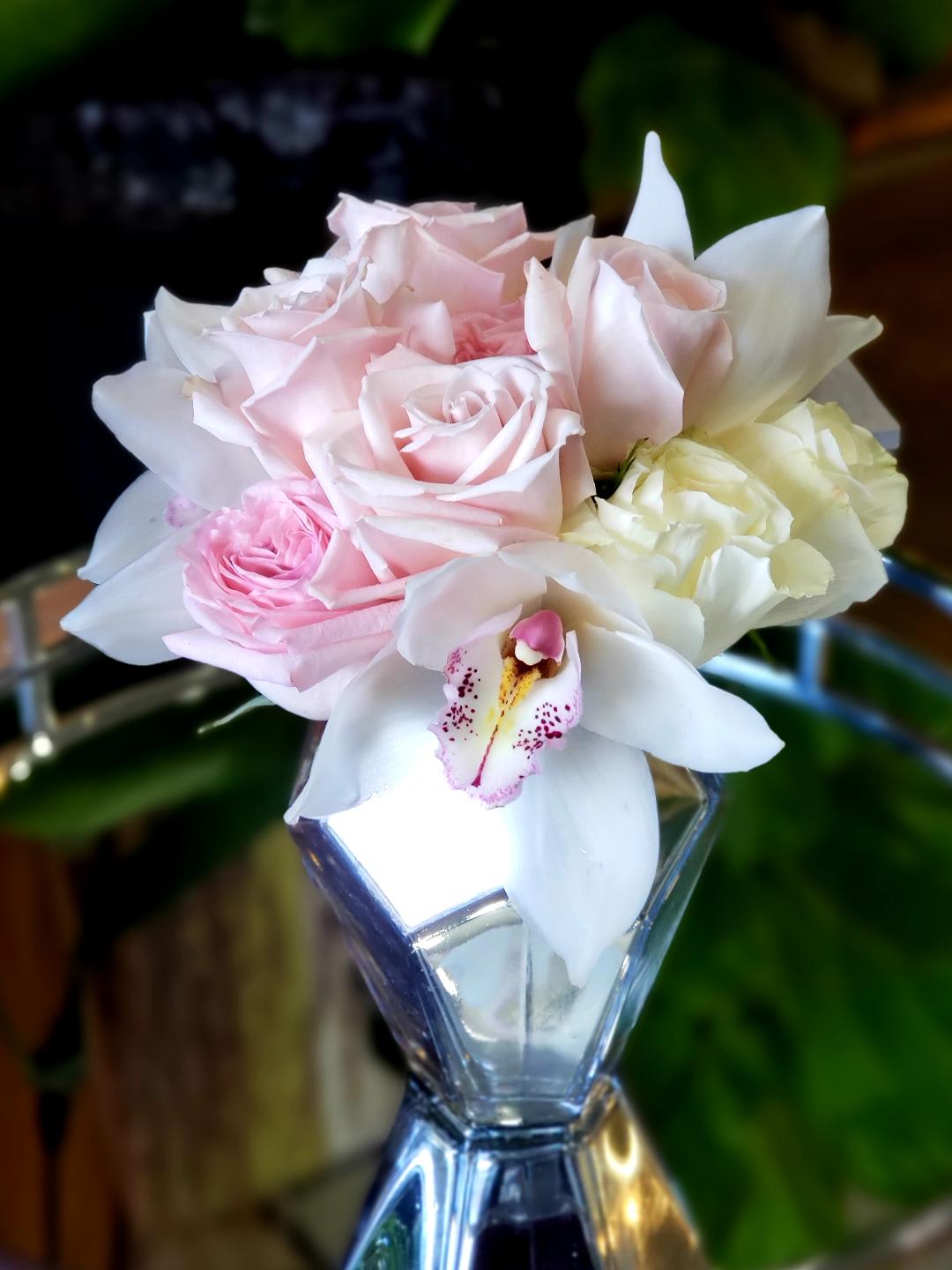  Roses, Cymbidium Orchids - Pretty in Soft Pink and White Roses with Orchids incorporated beautifully in a silver vase.