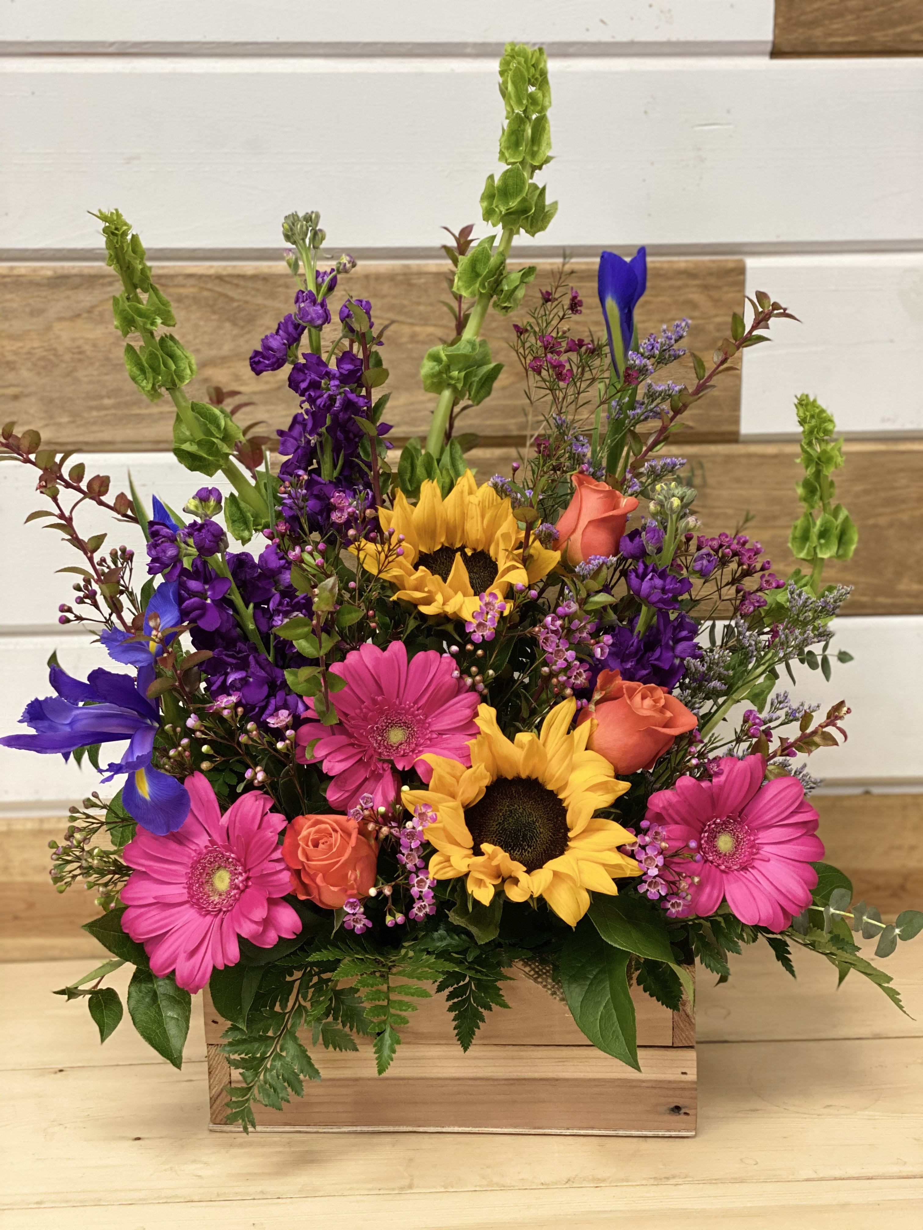 Rustic Signature Wood Box - This is definitely one of our favorites!   We add a bright seasonal mix of the best Spring flowers which can include: Tulips, Iris, Lilies, Ornamental Kale, and much more. These flowers come straight from our growers on the Watsonville coast three times a week to guarantee FRESHness. 
