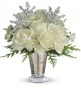  Teleflora’s Winter Glow    - Gorgeous white roses, asiatic lilies and miniature carnations are beautifully arranged with magical silver snowflakes and delivered in a glamorous silver Mercury Glass Vase. Glow ahead and send this stunner today! Approximately 11&quot; W x 11 1/2&quot; H