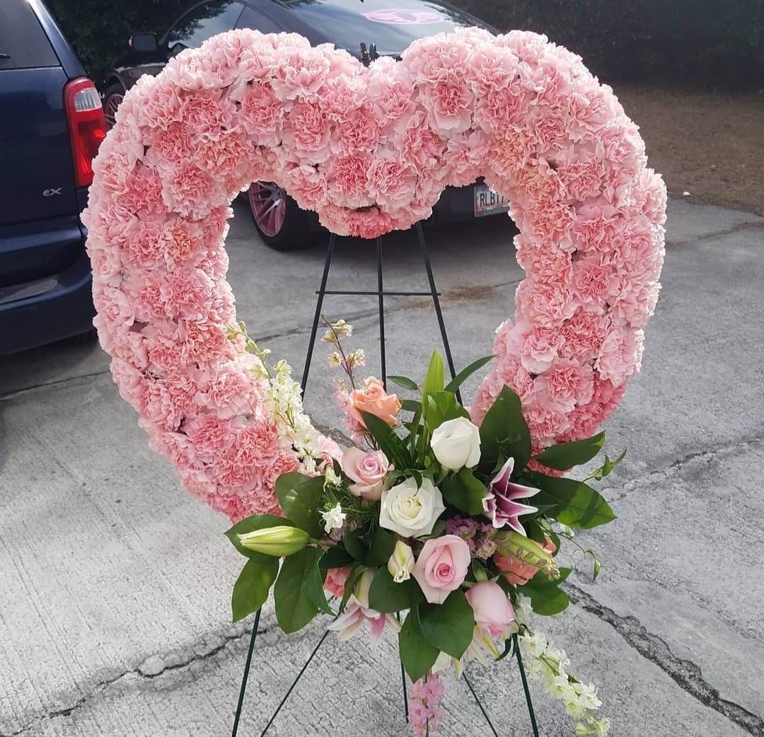 Pink Carnation Open Heart Pink Carnation Open Heart - This large open heart is lined with pink carnations and has a mix of different flowers at the bottom tip.