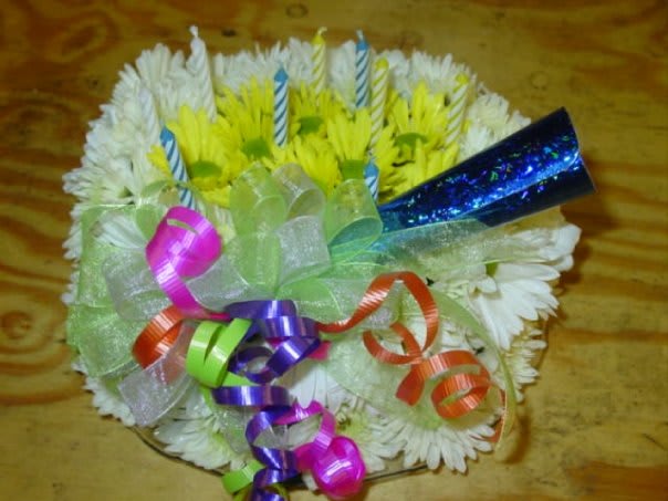 Fresh Floral Birthday Cake Fresh Floral Birthday Cake - Birthday shaped cake out of fresh white flowers accented with yellow spray roses and birthday items