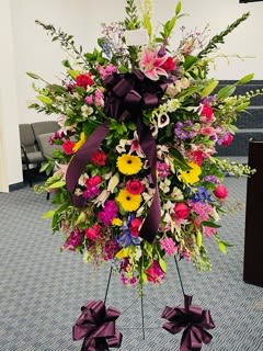 standing spray standing spray - A elegant gesture of thoughts and love featuring roses, gerbera daisies, lilies and orchids. colors can vary and will build to suit