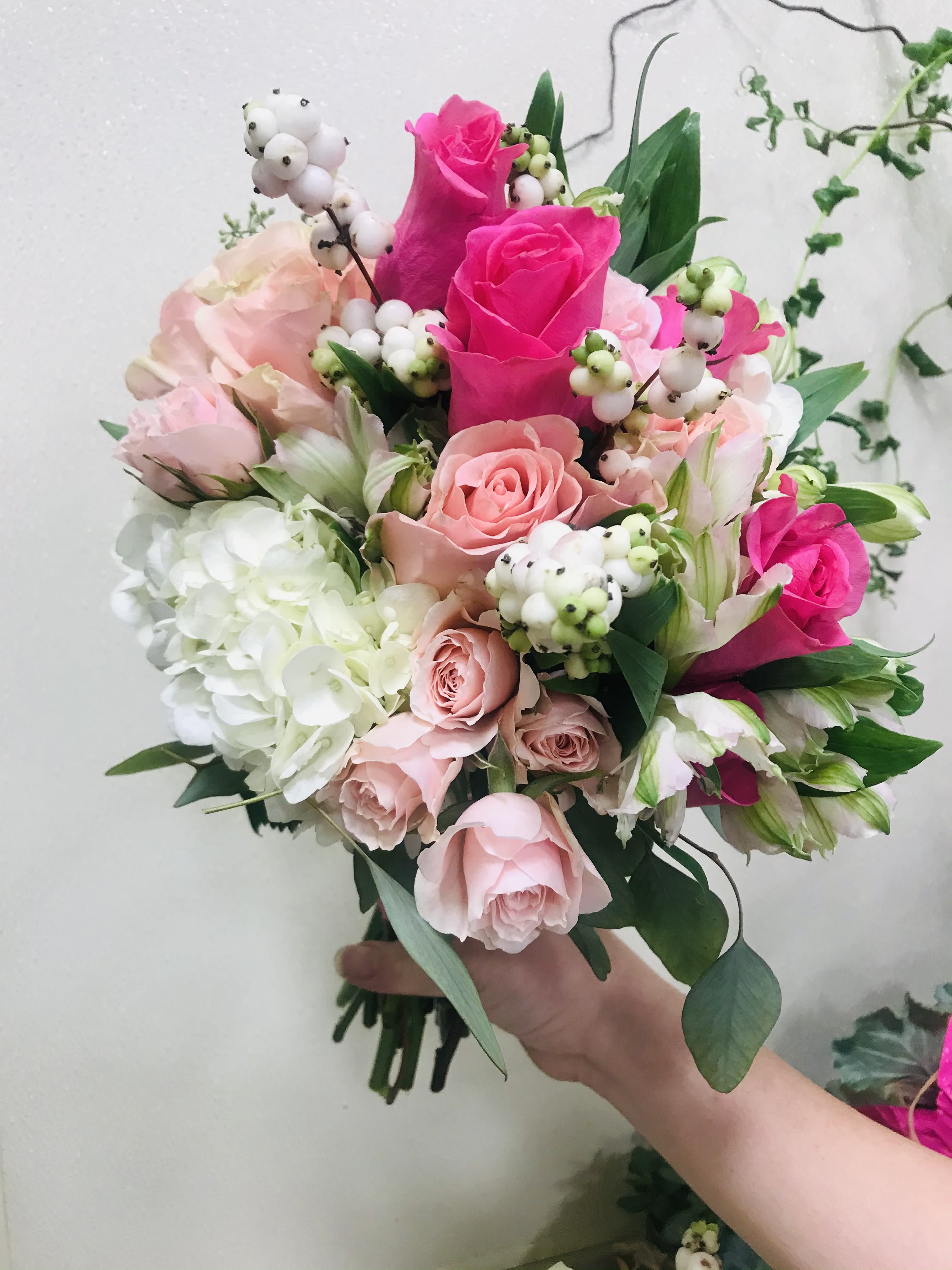 Pretty in Pink - Lovely hand-tied bouquet in hot pinks roses, white hydrangea and fillers.