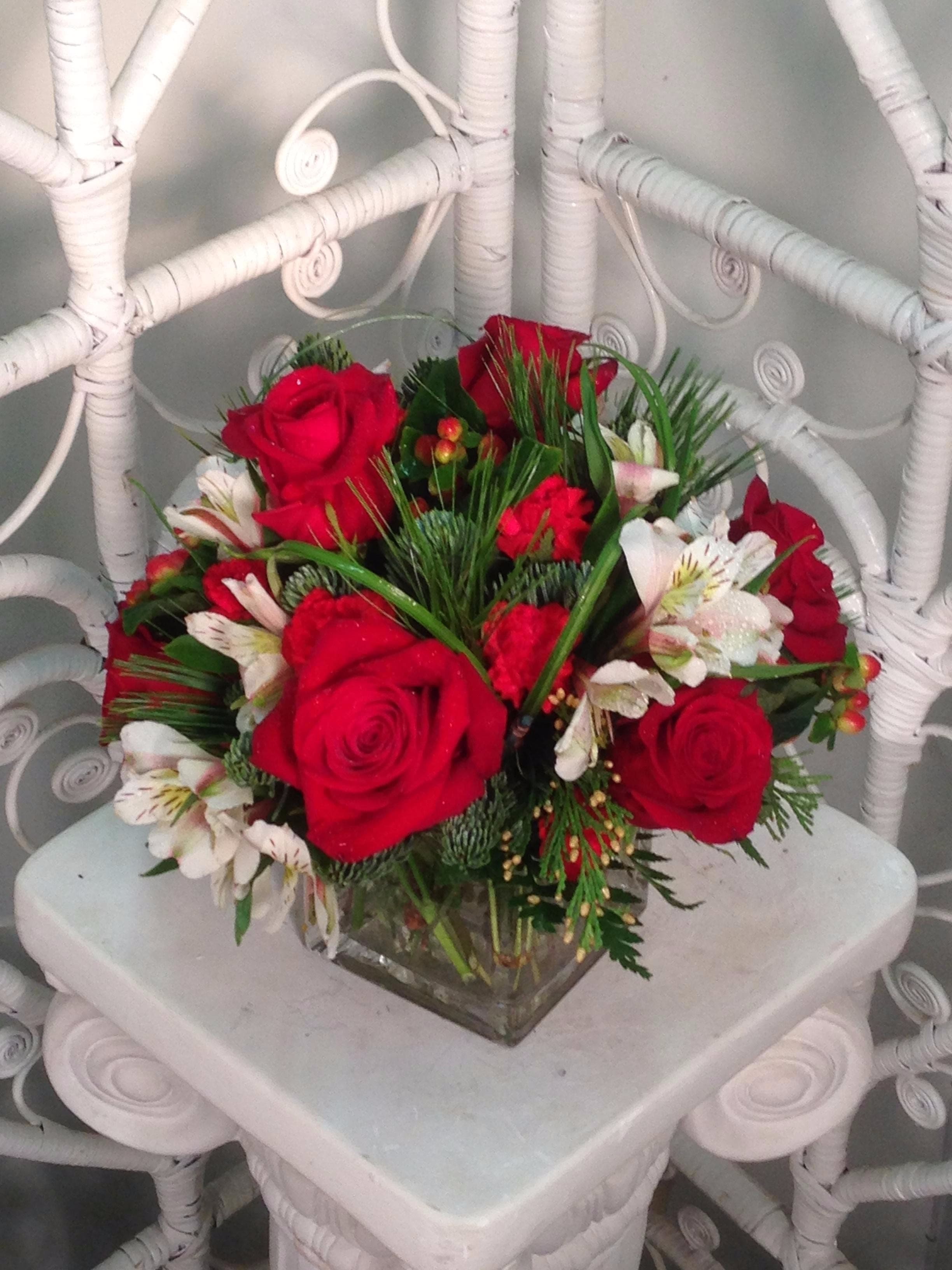 High Hopes High Hopes - Red roses, white alstroemeria, and red mini carnations set amid fragrant evergreens and red berries, accentuated with arching blades of lily grass.