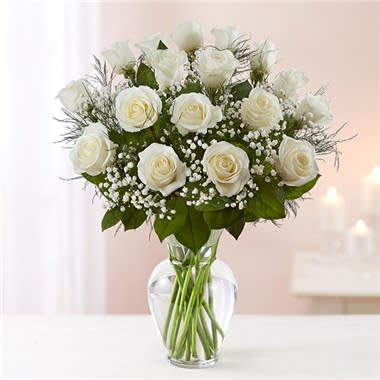 1-800-Flowers® Rose Elegance™ Premium Long Stem White Roses - Our pristine white roses are an elegant surprise for someone who brings pure joy to your life. Beautifully arranged by our expert florists with lush greenery inside a classic glass vase, 12 or 18 delicate blooms are hand-delivered and ready to delight the people you care about for big celebrations and every “just because” moment in between. All-around arrangement with 12 or 18 long stem white roses; accented with baby’s breath and assorted greenery Our florists select the freshest flowers available, so shade of rose may vary due to local availability Artistically designed in a clear glass vase 18-stem arrangement measures approximately 22&quot;H x 16&quot;L