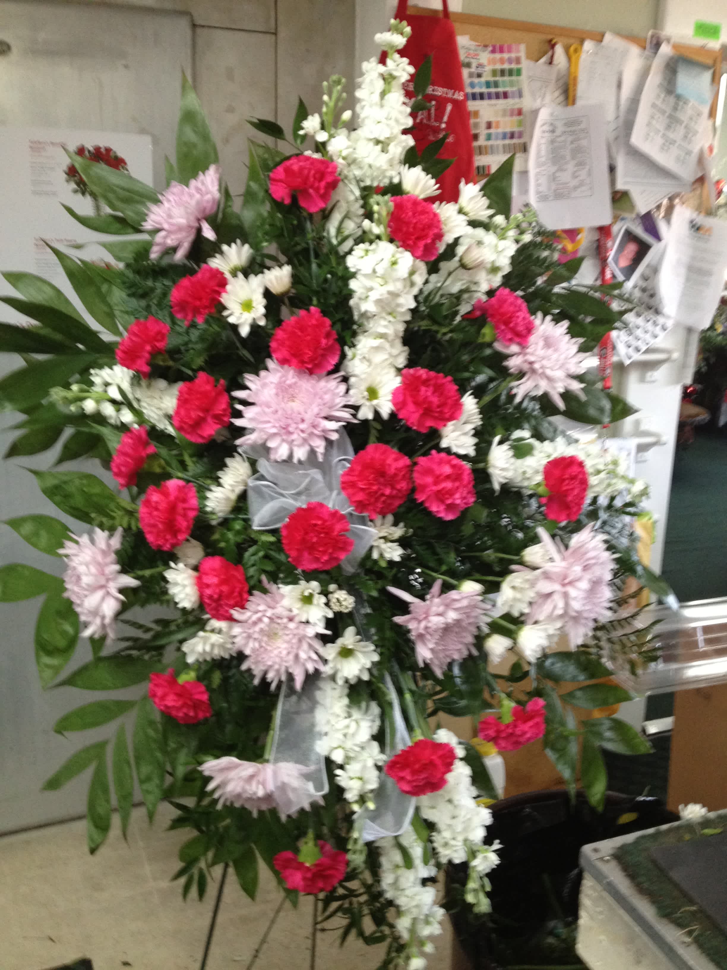 Pink and White Spray - * Hot Pink Carnations * Lavender Spider mums * White Stock * White daisies * 48&quot; Easel Send this lovely pink, lavender and white standing spray to convey your heartfelt sympathy. This spray can be designed in other color schemes to suit your tastes.