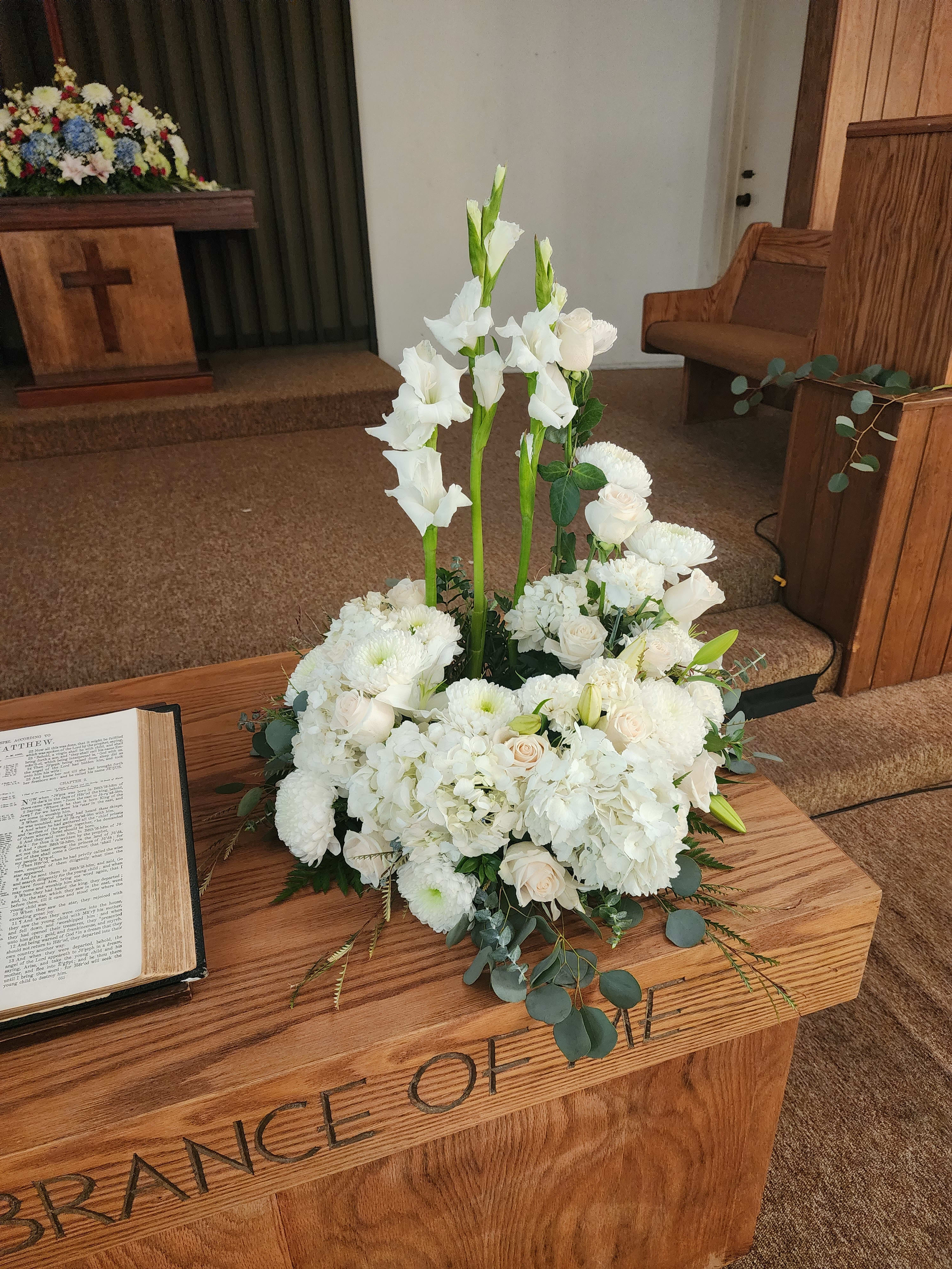 Serenity by Barrio Logan Florist  - An all white tribute, this all white funeral urn is pure and tranquil. Featuring a variety of white flowers, this urn arrangement compliments the beauty of life. 