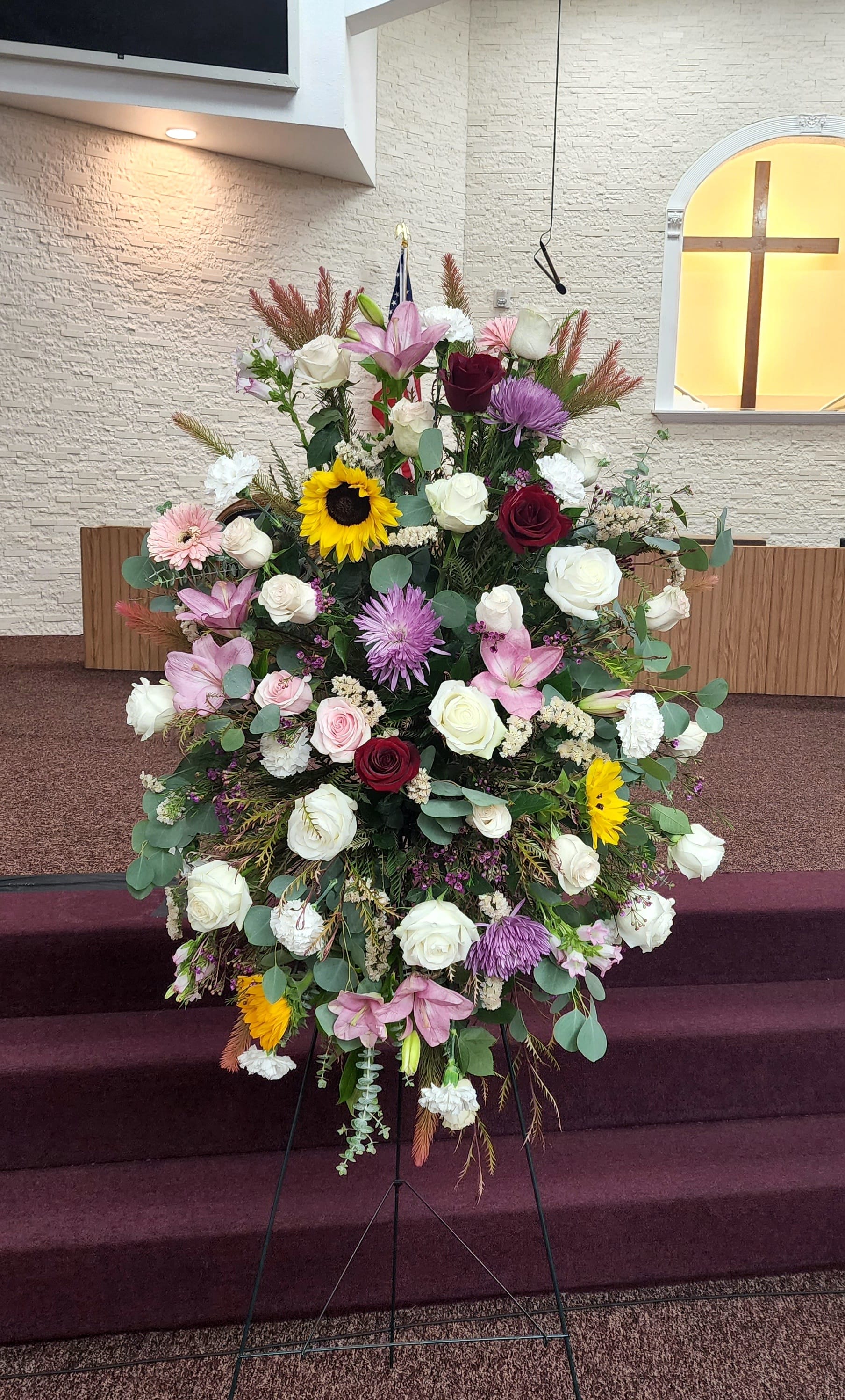 Compassion by Barrio Logan Florist  - Pink roses, lilies, and more come together for a blushing pink standing funeral spray. 