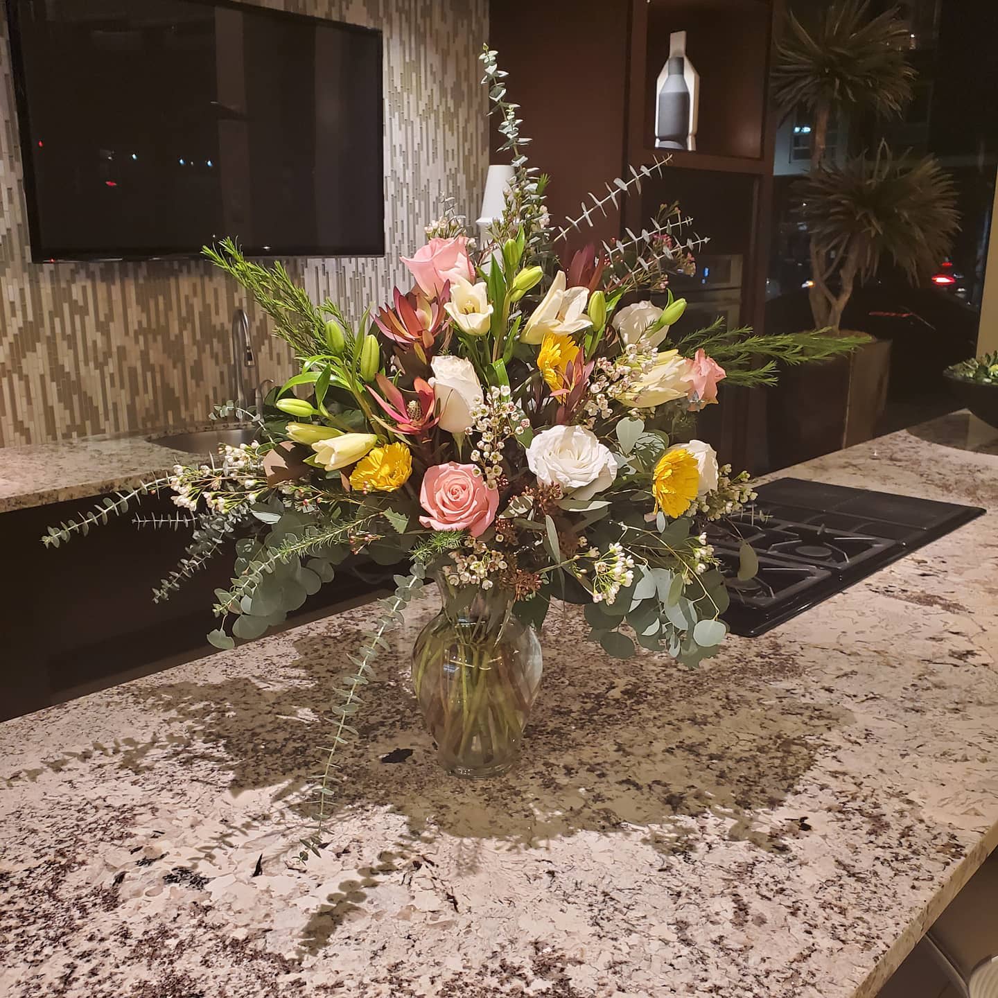 Sugar by Barrio Logan Florist  - Sugar by BloomNation™ is the most whimsical way to sweeten somebody's day. This beautiful boho arrangement with eucalyptus, peach roses, and white ranunculus in a moon shaped vase elevates any space. Perfect for Women's Day, Mother's Day, or any birthday.   APPROXIMATE DIMENSIONS: 22&quot; W x 20&quot; H