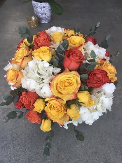 Illumination Illumination - Birghten up someones day with orange and yellow flowers. The arrangement shown in the photo is