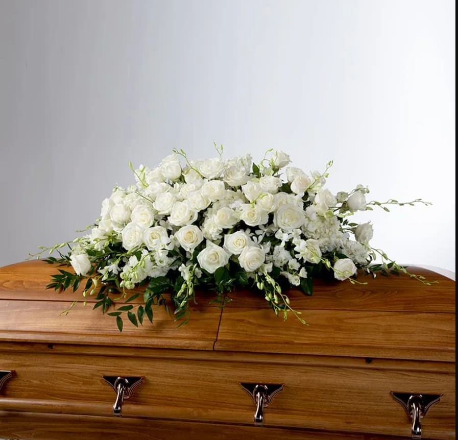 Tranquility by BloomNation™  - An all white tribute, this full casket spray is pure and tranquil. Featuring a variety of white flowers and greenery, this elegant spray evokes a feeling of peace. 
