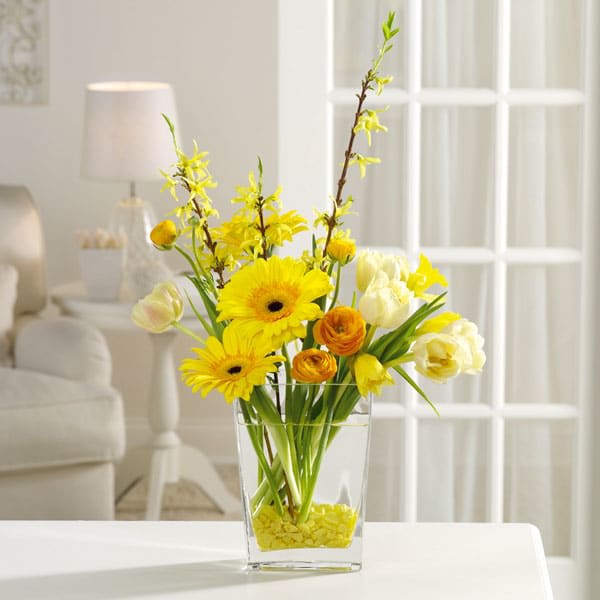 Yellow Fever - Think spring all year long with this celebration of sunshine blossoms - forsythia, yellow Gerbera daisies, orange ranunculus and white tulips.