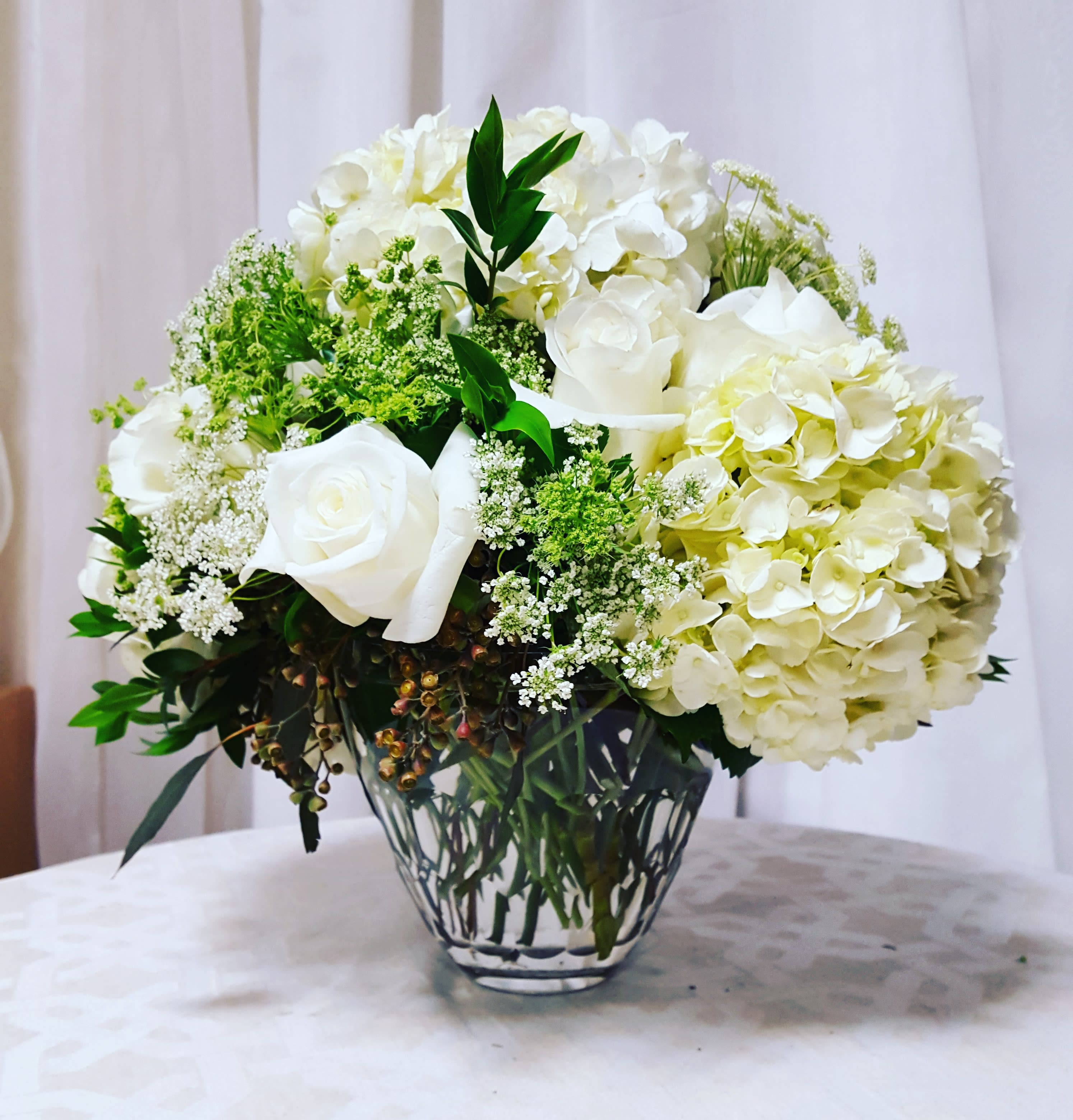 White Beauty White Beauty - A graceful collection of soft whites and tranquil greens come together in this design to make a classy arrangement perfect for any occasion. Key notes for this design are hydrangea, roses, and white/green flowers.
