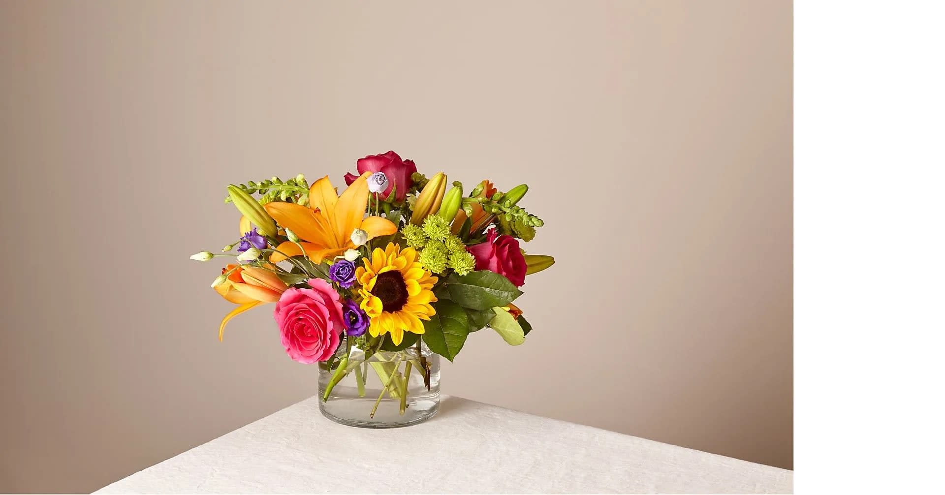 Best Day Bouquet (Vase will vary) - Make this day their best day. Our local florist handcraft a colorful array of flowers in a clear glass vase to create a celebration in bloom. Perfect to give for a special reason or to simply share a smile. Complete with Lilies, Roses, Snapdragons and Sunflowers.