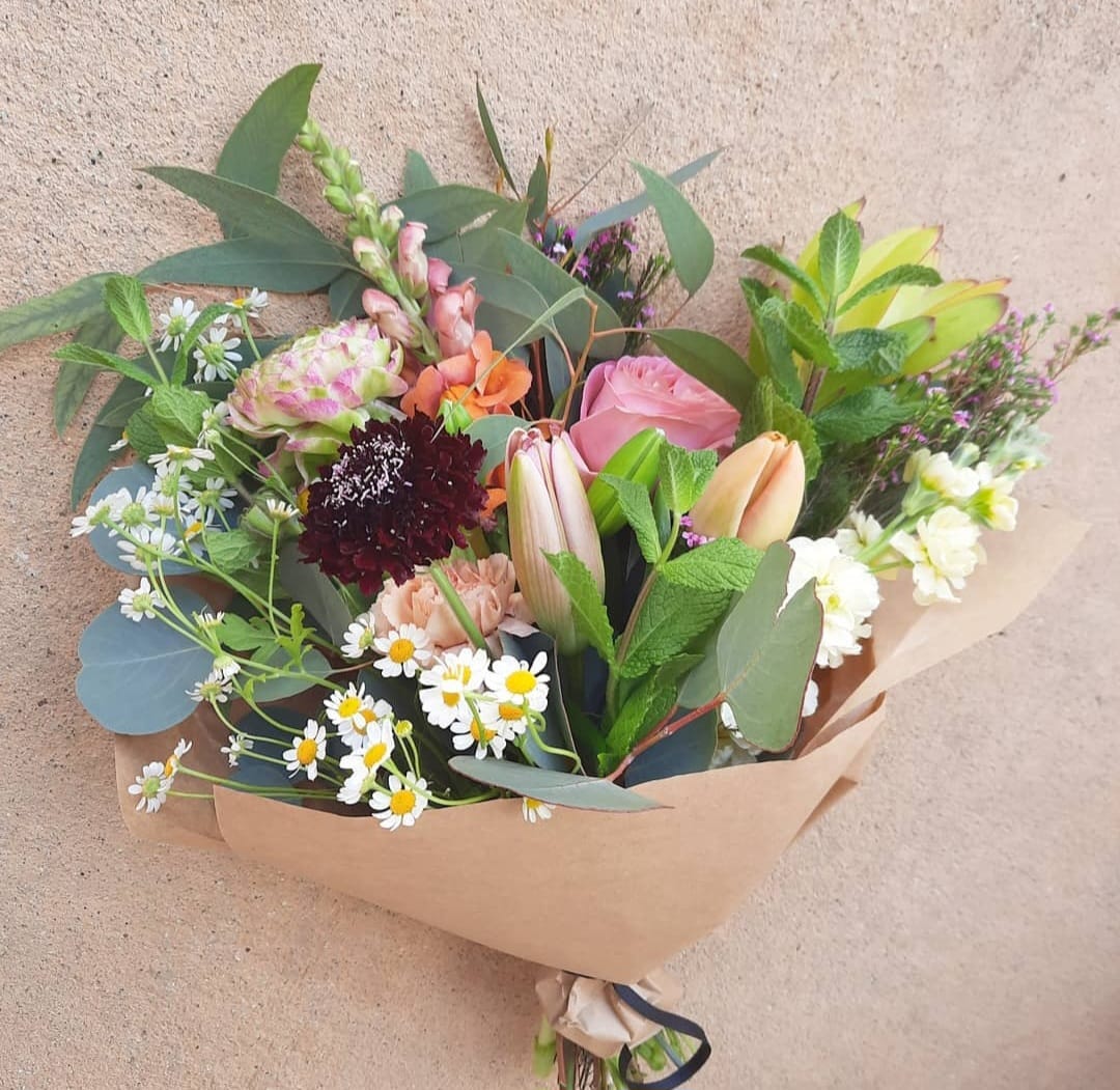 Designer Choice Beauty Girl Bouquet - This signature designers choice bright wrap is a stunner of bouquet .  Color palette and overall look and design will remain the same, types of flowers may vary depending on the season and availability.