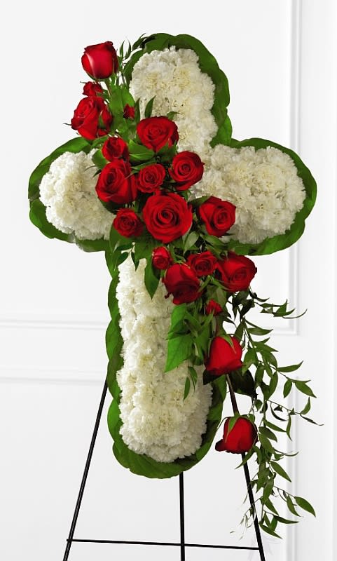 Floral Cross Floral Cross - The floral cross-shaped standing spray is a beautiful symbol of eternal love and faith commemorating the departed at their final farewell service. White carnation blooms are arranged to form a religious symbol and are accented with rich red rose and greenery.