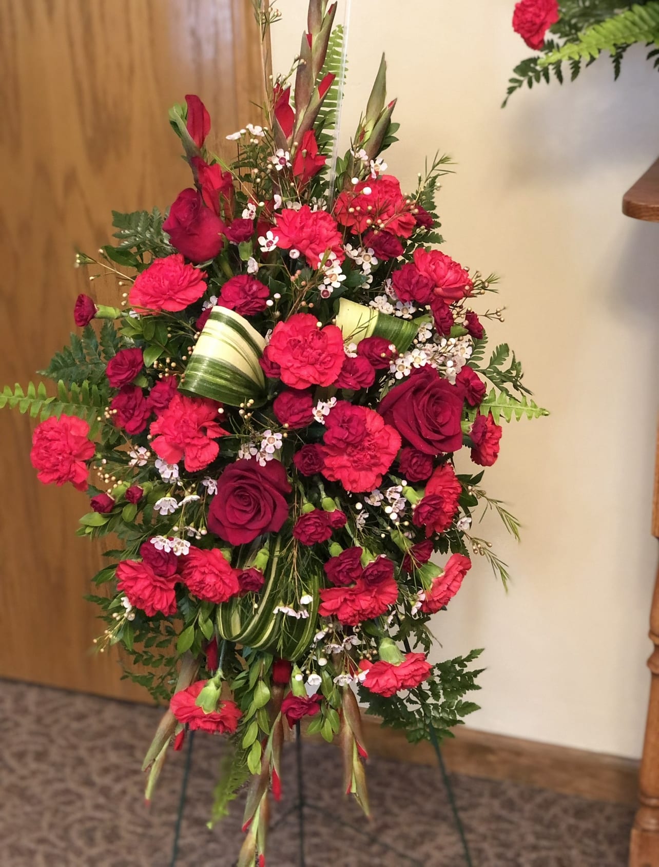 Deepest Heartfelt Sympathy  - This rich radiant spray of red roses, gladiolus and other popular red flowers during a time of loss conveys a message of reassurance and hope in a difficult time. 