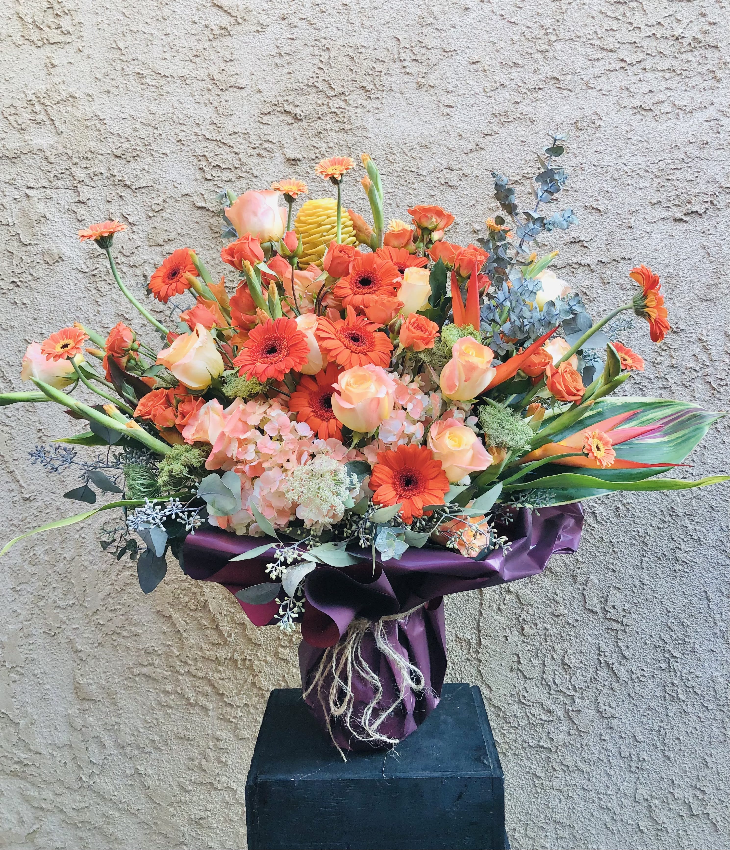 Wild Peach - Beautiful peach and green vase arrangement featuring roses, gerbera daisies, hydrangeas, and green leaf accents
