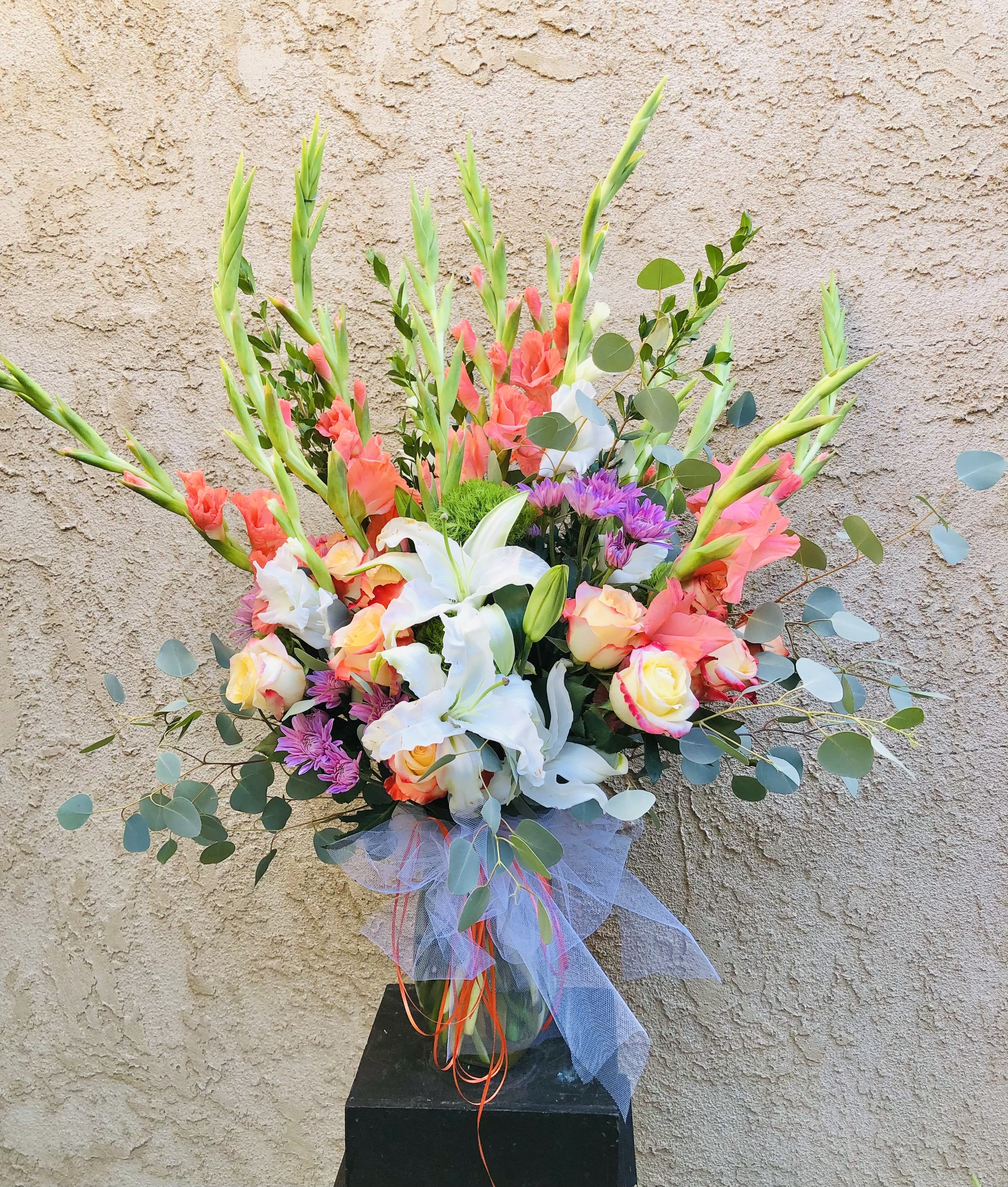 My Gratitude - Beautiful peach, purple, and white vase arrangement featuring lilies, roses, gladiolus, mums, and leaf accents
