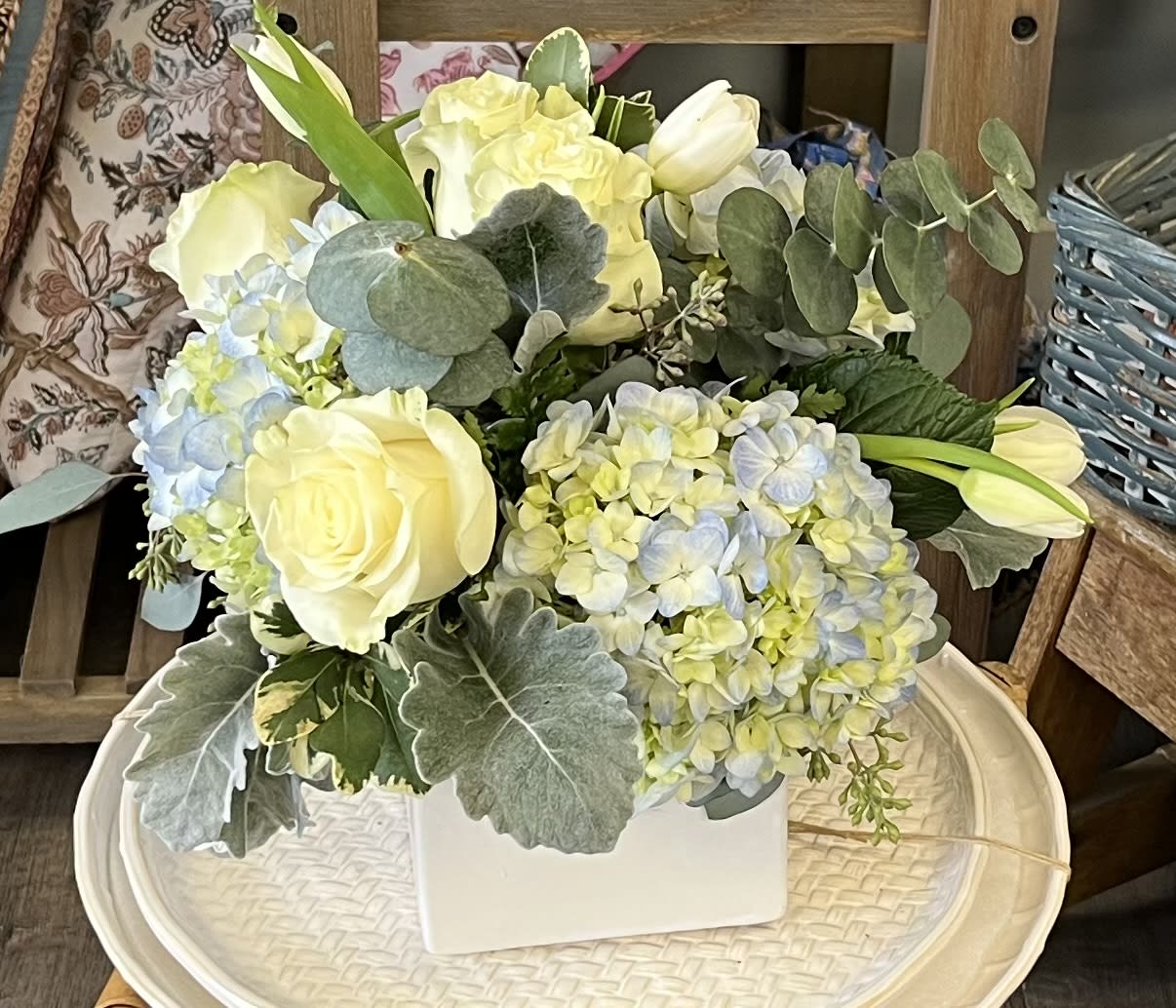 Simplicity - This arrangement includes blue hydrangea, white roses and tulips.