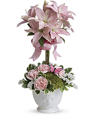 Teleflora's Blushing Lilies - Send this blushing beauty of perfectly pink lilies and light pink carnations arranged in our charming french country pot-the perfect gift to ring in spring! Pink asiatic lilies are arranged into a topiary bouquet surrounded by a base of light pink carnations, variegated pittosporum and white statice.