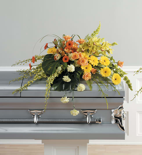 Sweet Farewell Casket Spray Sweet Farewell Casket Spray - Our Sweet Farewell Casket Spray is an outstanding way to honor the life ofyour loved one. This spray includes bright yellow and orange gerbera daisies, lush orchids, vibrant tulips, beautiful green Bells of Ireland, and soft green carnations. Approximately 48" width In some instances, flower substitutions may be made. Colors, style, and value will remain close to the same as the general style and theme of the original arrangement.