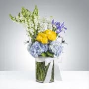 Best in Blue by BloomNation™ - This tall reaching arrangement brings light to any space. A mix of blue and yellow flowers, this arrangement is the perfect way to welcome a new baby, say happy birthday or give thanks.   APPROXIMATE DIMENSIONS 12&quot; W X 20&quot; H